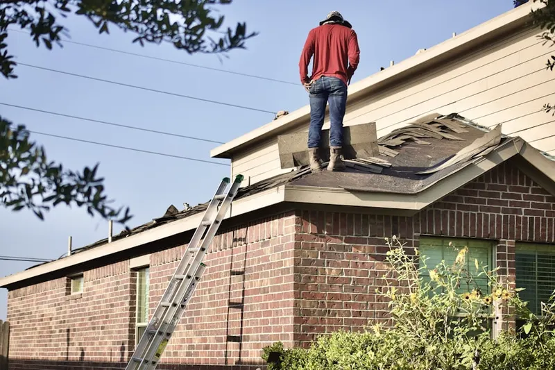 Professional roofer working on a residential roof in Lippincotts Corner